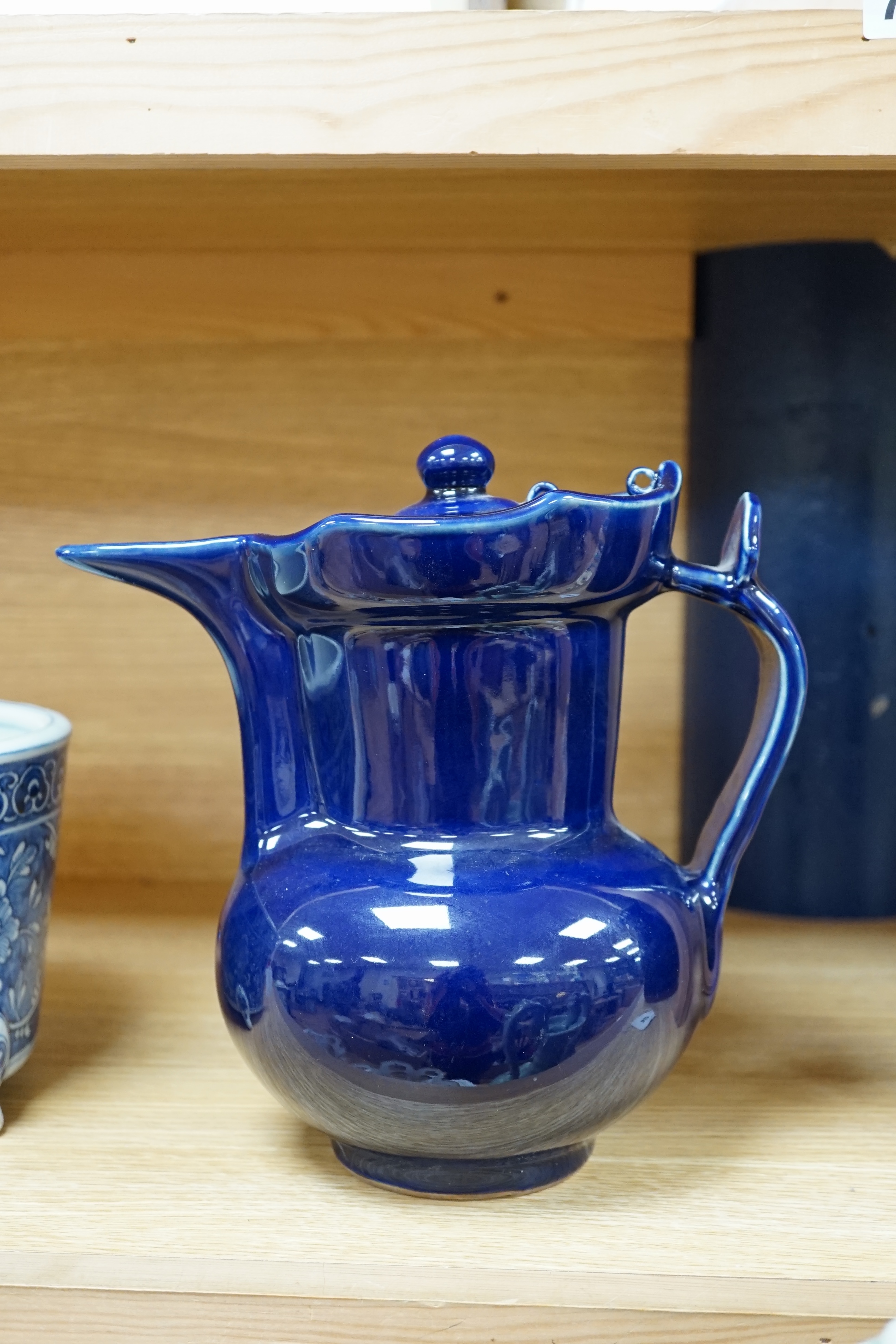 A Chinese dark blue glazed ewer and cover, 23cm high. Condition - good